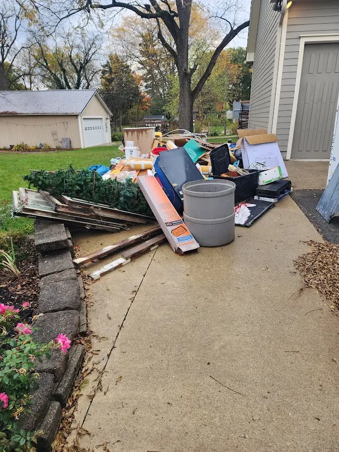 Dumpster being loaded with debris for 12 Yard Dumpster Rental in San Miguel